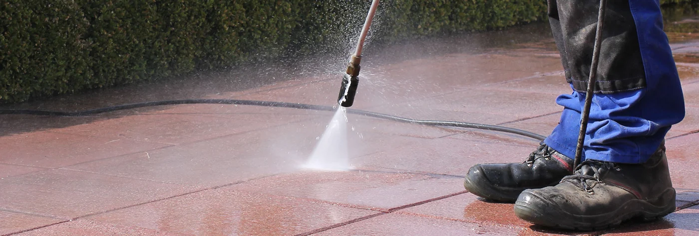 Pressure washing a paved patio
