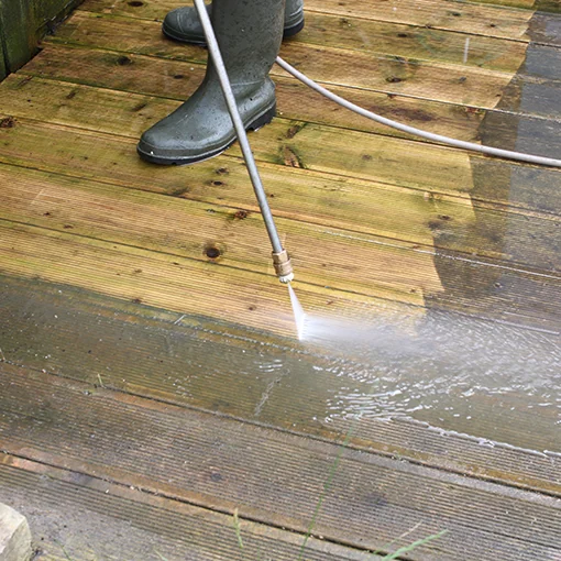 Removing surface dirt from timber decking with a pressure washer