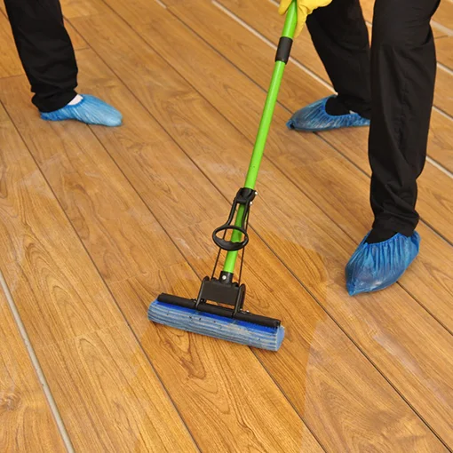 Cleaner mopping a wooden floor