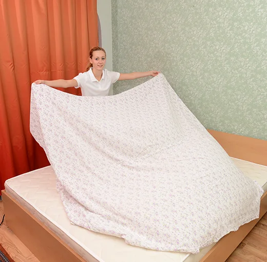 Changing bed linen in a bedroom