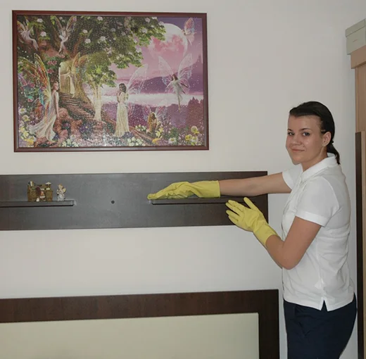 Cleaner wiping a shelf
