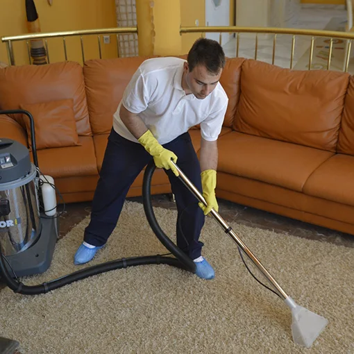 Vacuuming upholstery on a sofa