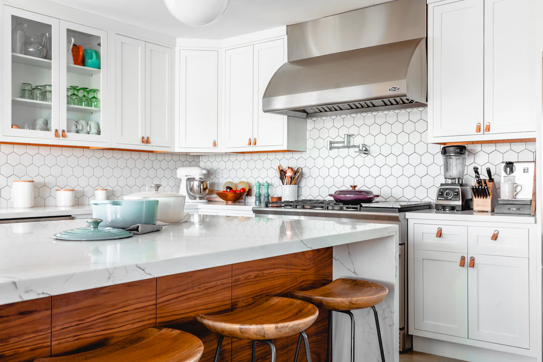 Bright kitchen with cupboards and a tiled splashback