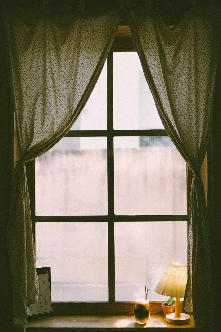 Curtains hanging beside a living room window