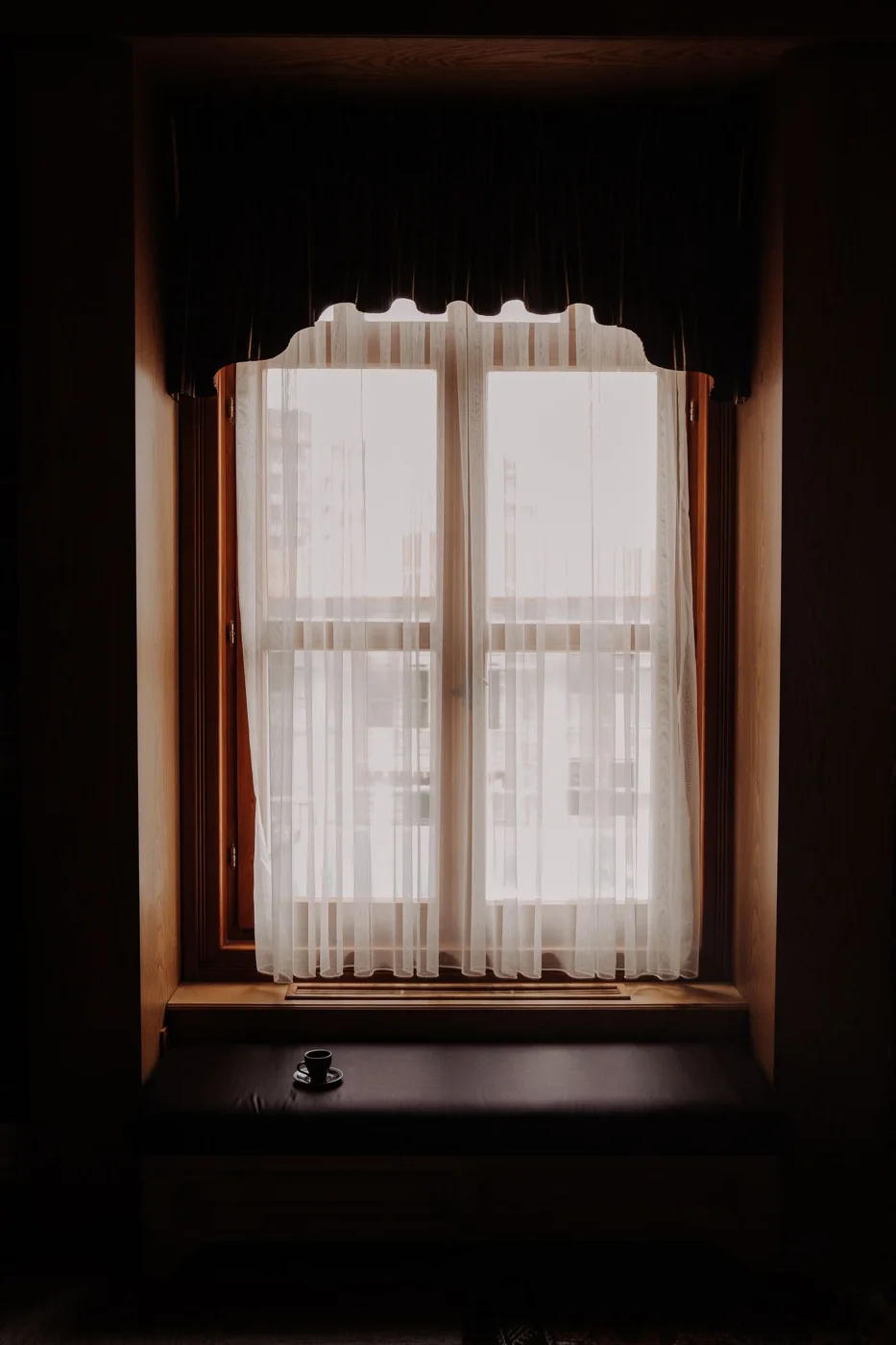 Light filtering through a sheer curtain