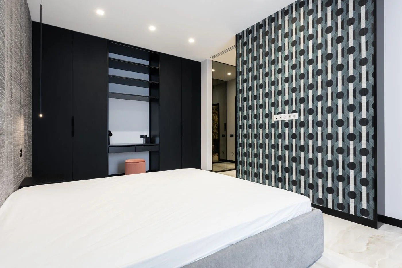 Mattress on a bed beside a wardrobe