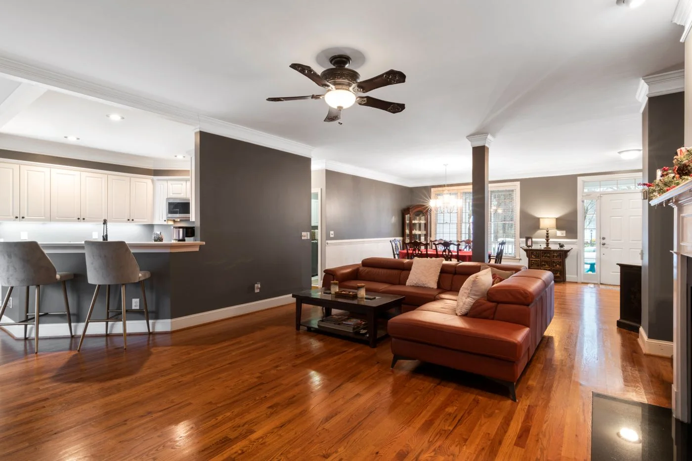 Leather seating in a living room with an open kitchen