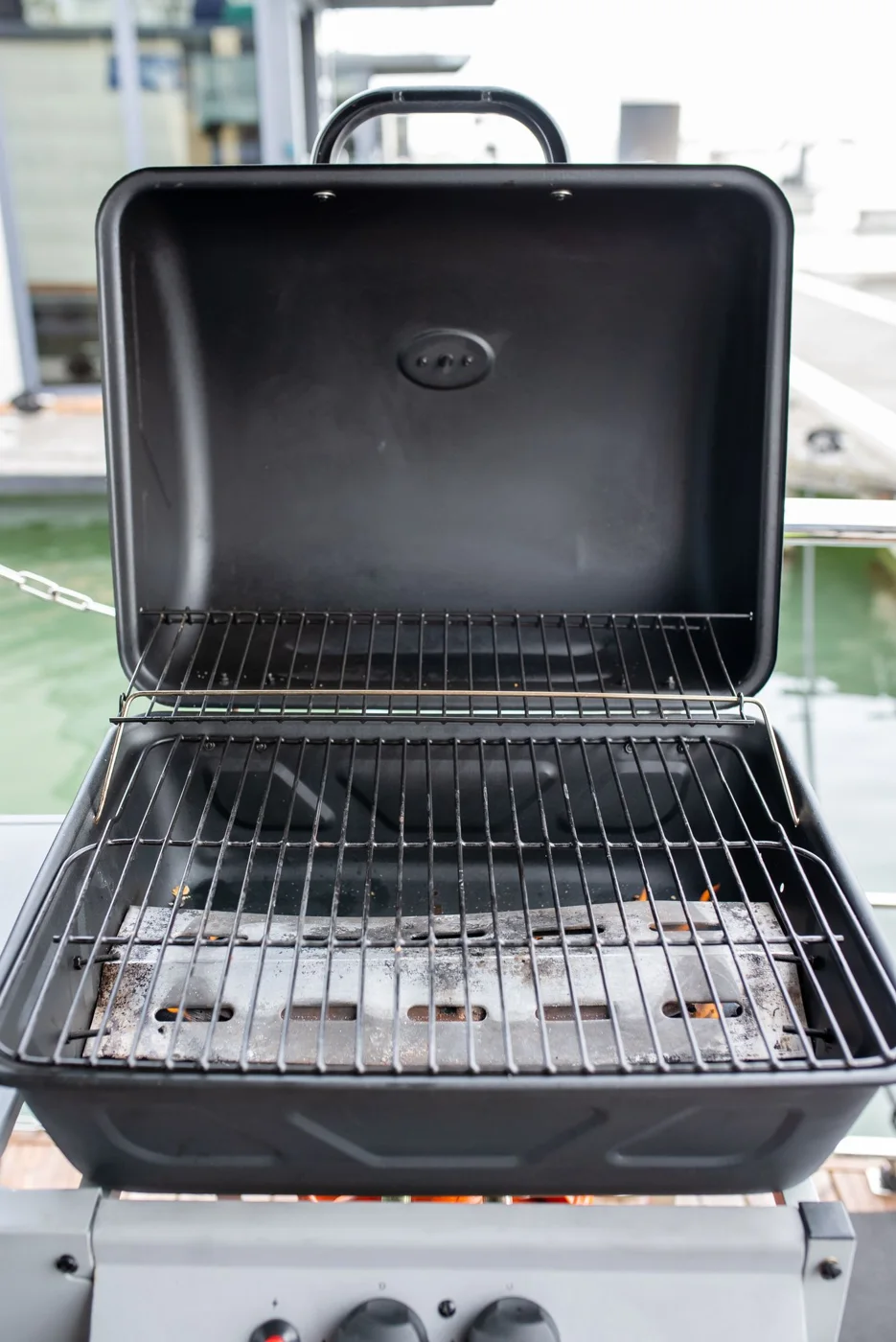 Open barbecue with an empty cooking grate