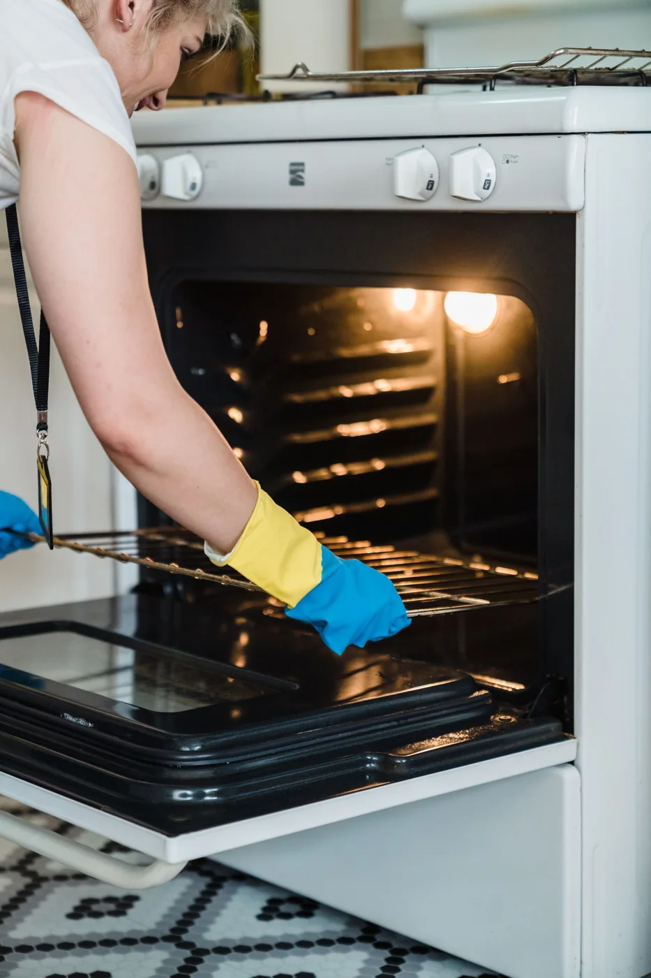 Oven rack being handled during cleaning